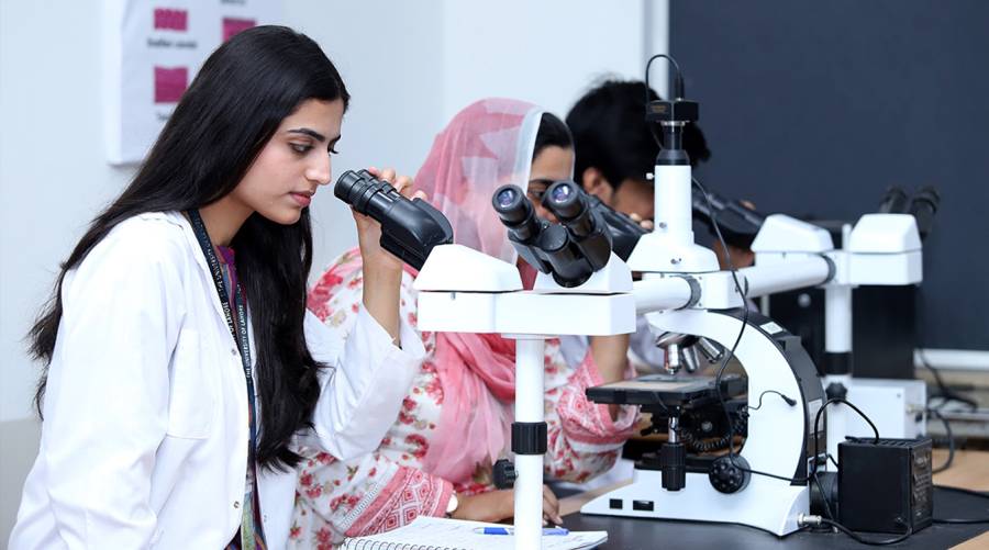 A group of medical and dental students in Pakistan attending a lecture, symbolizing the future of healthcare education as PMDC introduces a standardized fee structure for private colleges.